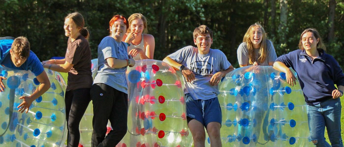 学生 lined up to play bubble soccer